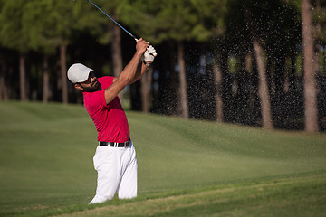 Image showing golfer hitting a sand bunker shot