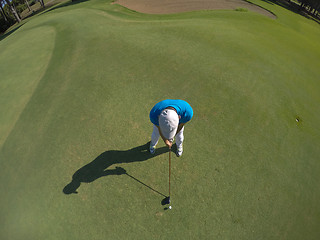 Image showing top view of golf player hitting shot