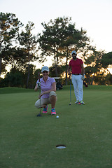 Image showing couple on golf course at sunset