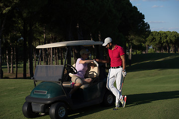 Image showing couple in buggy on golf course