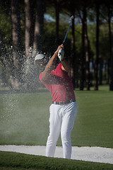 Image showing golfer hitting a sand bunker shot