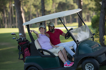 Image showing couple in buggy on golf course