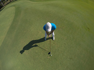 Image showing top view of golf player hitting shot