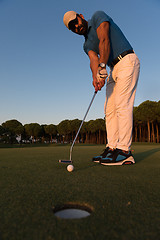 Image showing golfer  hitting shot at golf course