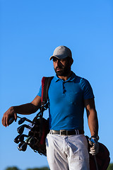 Image showing golfer  portrait at golf course on sunset