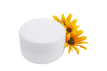 Image showing Spa cosmetic cream and flowers isolated on white