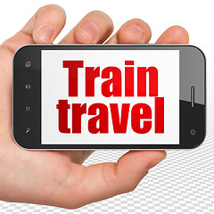 Image showing Vacation concept: Hand Holding Smartphone with Train Travel on display