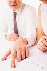 Image showing Businesswoman and businessman pointing at document in office isolated