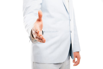 Image showing Close up of businessman hand extended to handshake isolated on white 