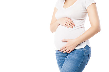 Image showing Unrecognizable pregnant woman embracing belly