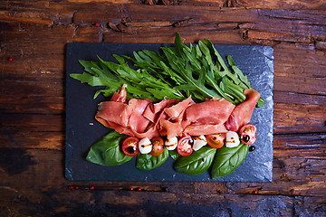 Image showing plate of salad with cherry tomatoes, arugula,