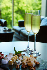 Image showing two glasses of champagne with a tray cheese