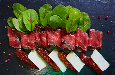 Image showing slices ham with cheese and leaves of beets