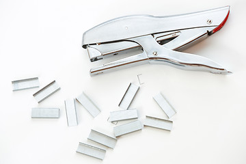 Image showing Staples and stapler on white background