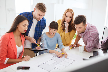 Image showing creative team with blueprint working at office