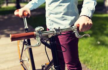 Image showing close up of young hipster man with fixed gear bike