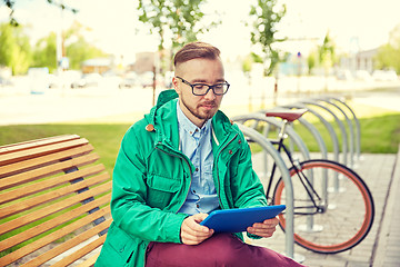 Image showing happy young hipster man with tablet pc and bike