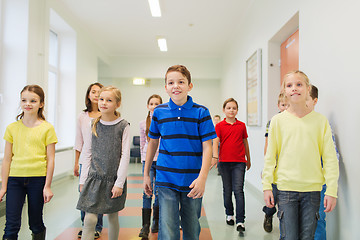 Image showing group of smiling school kids walking in corridor