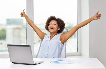 Image showing happy african woman with laptop at office