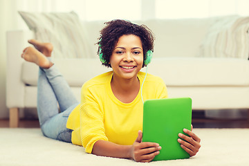 Image showing happy african woman with tablet pc and headphones