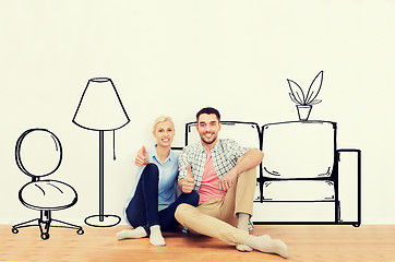 Image showing happy couple showing thumbs up at new home