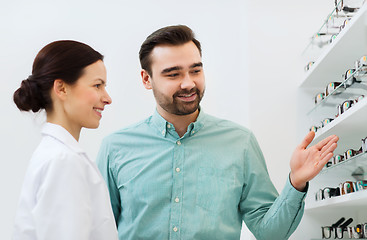 Image showing optician and man choosing glasses at optics store