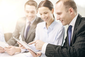 Image showing business team with tablet pc having discussion