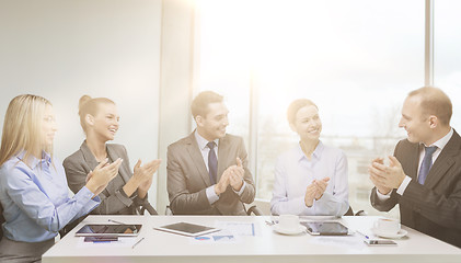 Image showing business team with laptop clapping hands