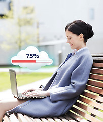 Image showing smiling business woman with laptop in city