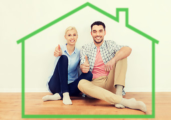 Image showing happy couple showing thumbs up at new home