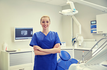 Image showing happy young female dentist at dental clinic office