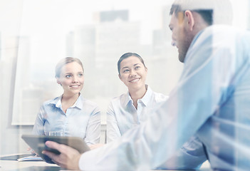 Image showing smiling businesspeople with tablet pc in office