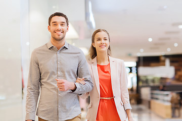 Image showing happy young couple with shopping bags in mall