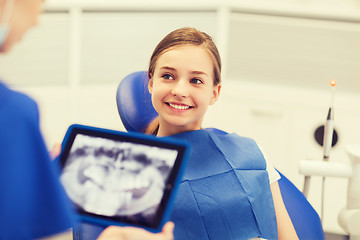 Image showing dentist with x-ray on tablet pc and girl patient