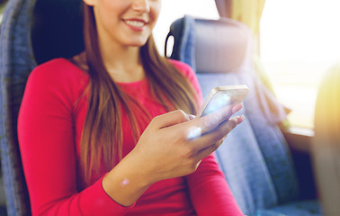 Image showing close up of woman in travel bus with smartphone