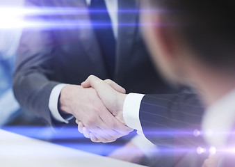 Image showing two businessmen shaking hands in office