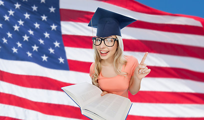 Image showing student woman in mortarboard with encyclopedia