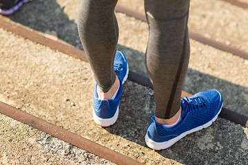 Image showing close up of sporty man legs in shoes on stairs