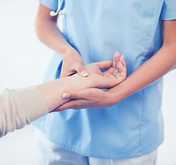 Image showing nurse with patient measuring pulse