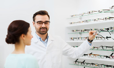 Image showing woman and optician showing glasses at optics store