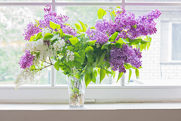Image showing Lilac bouquet in vase on window