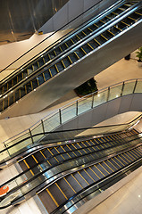 Image showing Looking down at multiple escalators