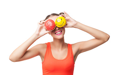 Image showing Young smiling woman covering eyes with donuts