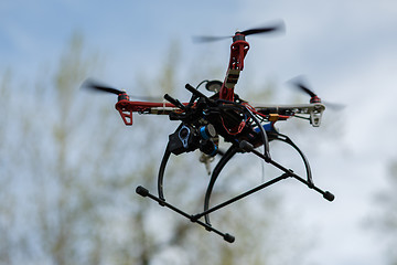 Image showing flying drone with camera on the sky