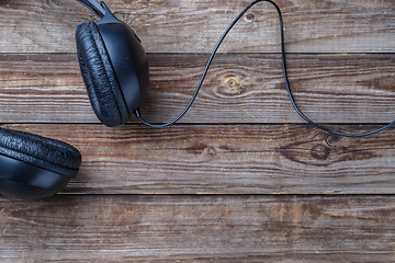 Image showing Headphones over wooden table.