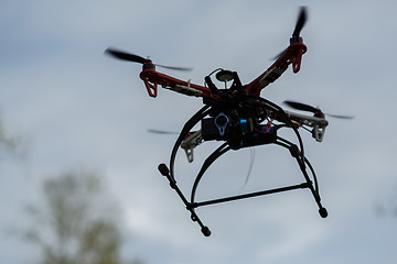 Image showing flying drone with camera on the sky