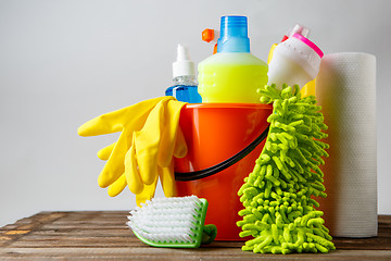 Image showing Bucket with cleaning items on light background