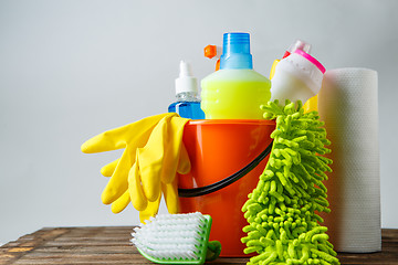 Image showing Bucket with cleaning items on light background