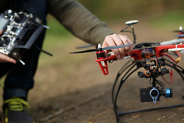 Image showing Closeup of man hand fixing propeller drone 