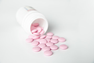 Image showing Close-up of pink scattered pill from bottle